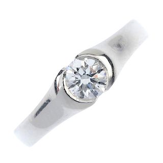 A platinum diamond single-stone ring. The brilliant-cut diamond, weighing 0.51ct, to the tapered ban