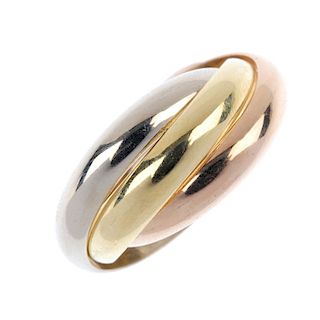 CARTIER - a 'Trinity' ring. Of tri-colour design, comprising three interwoven bands. Signed and numb