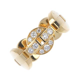 CARTIER - an 18ct gold diamond dress ring. Designed as a series of circular panels, with central bar