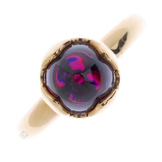CHIMENTO - an 18ct gold garnet single-stone ring. The garnet cabochon, within a vari-texture petal s
