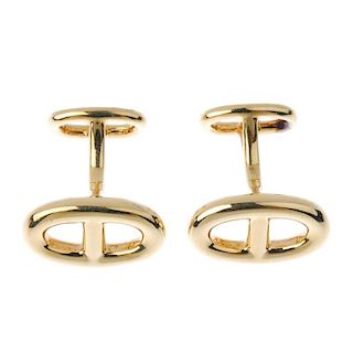 HERMES - a pair of 18ct gold cufflinks. Each designed as two bifurcated openwork oval panels, with b