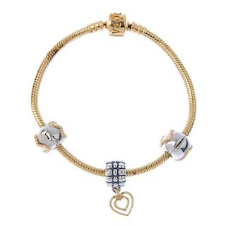 PANDORA - a charm bracelet. The snake-link chain, suspending three bi-colour heart-shape detail char