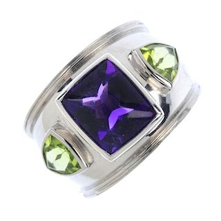 THEO FENNEL - an amethyst and peridot three-stone ring. The rectangular-shape amethyst collet and tr