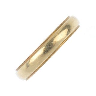 TIFFANY & CO. - a band ring. The plain band with millegrain border. Signed Tiffany & Co. Ring size L