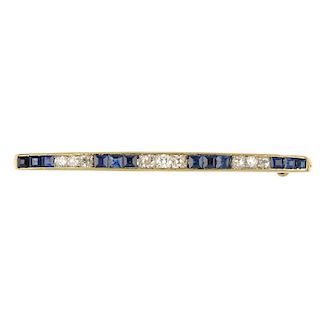 A diamond and sapphire bar brooch. Designed as an old-cut diamond and square-shape sapphire line, wi
