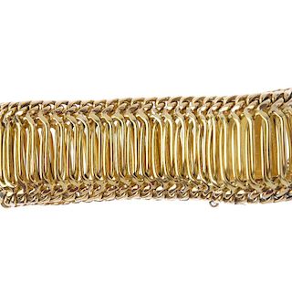 A bracelet. The oval-shape interwoven links, with flat-curb link sides, to the push-piece clasp. Len