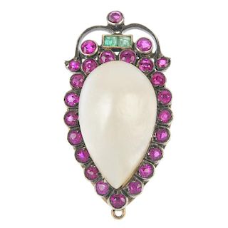 A mother-of-pearl, synthetic ruby and emerald brooch. The pear-shape mother-of-pearl cabochon, withi
