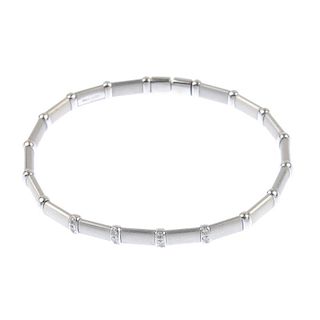 A diamond cuff. Designed as a series of rectangular textured panels, with polished bar spacers, to t
