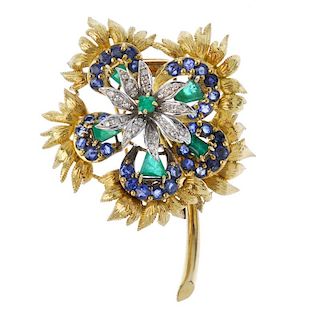 A mid 20th century diamond, emerald and sapphire spray brooch. The square-shape emerald and single-c