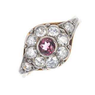 A tourmaline and diamond cluster ring. The circular-shape pink tourmaline collet, within a brilliant