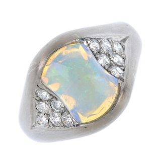 An opal and diamond dress ring. The cushion-shape opal cabochon, with brilliant-cut diamond triangla