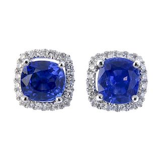 * A pair of sapphire and diamond cluster ear studs. Each designed as a cushion-shape sapphire, withi