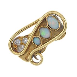 An 18ct gold opal and diamond dress ring. The graduated oval opal cabochon line and vari-cut diamond