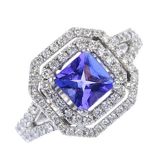 An 18ct gold tanzanite and diamond cluster ring. The square-shape tanzanite, within a brilliant-cut