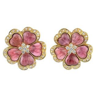 A pair of garnet and diamond floral ear clips. Each designed as a carved garnet flower, with brillia