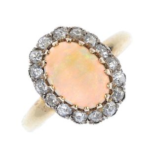 An opal and diamond cluster ring. The oval opal cabochon, within an old-cut surround, to the plain b