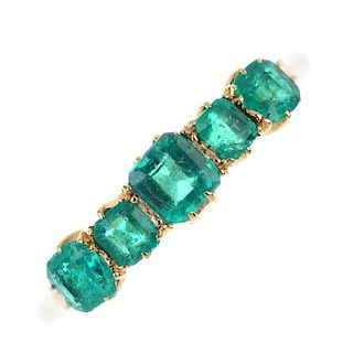 An emerald five-stone ring. The slightly graduated square-shape emeralds, to the plain band. Weight