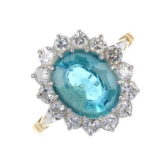 A tourmaline and diamond cluster ring. The oval-shape blue tourmaline, within a brilliant-cut diamon