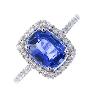 * A sapphire and diamond cluster ring. The oval-shape sapphire, within a brilliant-cut diamond surro
