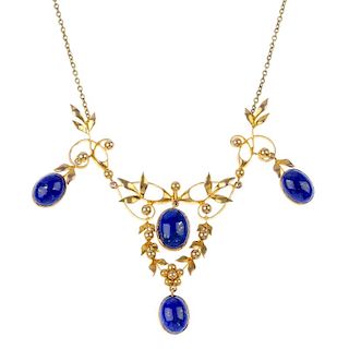 A lapis lazuli necklace. The front designed as a series of oval lapis lazuli drops, to the early 20t