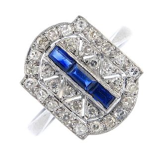 An 18ct gold sapphire and diamond ring. The calibre-cut sapphire line, within a single-cut diamond p