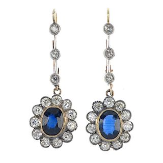 A pair of sapphire and diamond ear pendants. Each designed as an oval-shape sapphire and old-cut dia