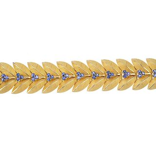 A 1960s 9ct gold sapphire bracelet. Designed as a series of textured twin leaf links, with circular-