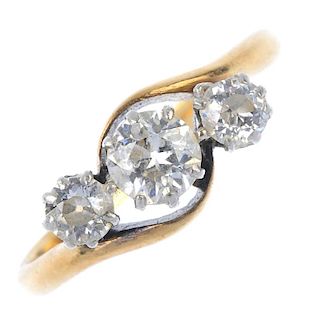 A mid 20th century 18ct gold and platinum three-stone diamond ring. The slightly graduated circular-