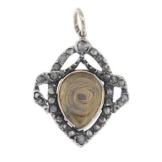 A late Victorian silver and gold diamond memorial pendant, circa 1900. The pear-shape hair panel, wi