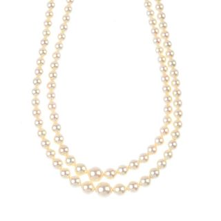 A cultured pearl two-row necklace. Comprising two-rows of 107 and 101 graduated cultured pearls, mea