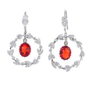 A pair of fire opal and diamond ear pendants. The oval fire opal cabochon, within a brilliant-cut di