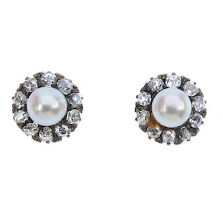 A pair of cultured pearl and diamond ear studs. Each designed as a cultured pearl, within an old-cut