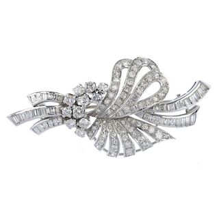 A diamond spray brooch. The single and brilliant-cut diamond floral spray, with baguette-cut diamond