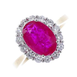 * A ruby and diamond cluster ring. The oval-shape ruby, within a brilliant-cut diamond surround, to