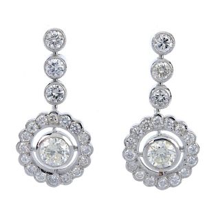 A pair of diamond earrings. Each designed as a brilliant-cut diamond, within a brilliant-cut diamond
