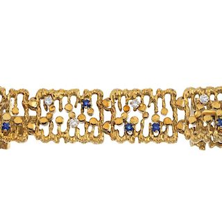 A 1970s sapphire and diamond bracelet. Designed as a series of textured openwork rectangular-shape l
