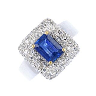 A sapphire and diamond cluster ring. The rectangular-shape sapphire, within a pave-set diamond borde