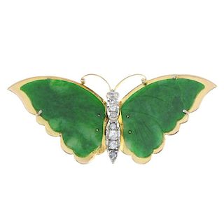 A jadeite and diamond butterfly brooch. The circular-shape diamond body, to the carved jadeite wings