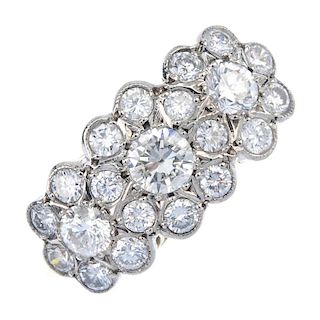 A diamond triple cluster ring. The brilliant-cut diamond clusters, to the tapered band. Estimated to