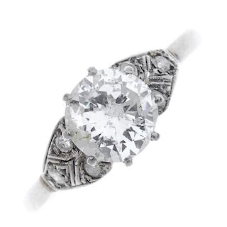 A diamond single-stone dress ring. The brilliant-cut diamond, to the similarly-cut diamond shoulders