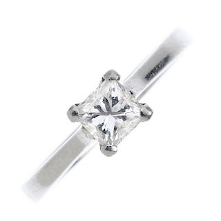A platinum diamond single-stone ring. The square-shape diamond, weighing 0.55ct, to the tapered shou