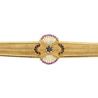A mid 20th century ruby and sapphire bracelet. The circular-shape sapphire cluster, within a similar