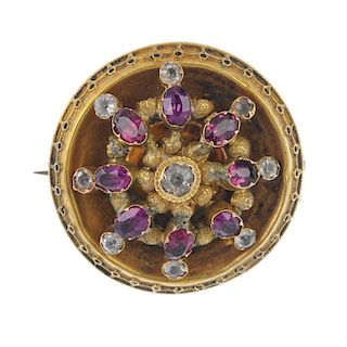 A Victorian gold gem-set brooch. The circular-shape greyish-blue gem collet, within an oval-shape ga