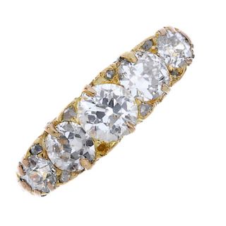 A late 19th century 18ct gold diamond five-stone ring. The slightly graduated old-cut diamond line,