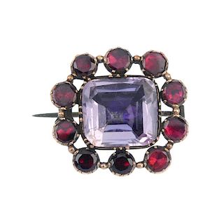 A late 19th century gold amethyst and garnet brooch. The rectangular-shape foil-back amethyst, withi