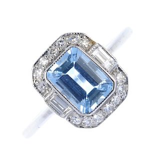 An aquamarine and diamond cluster ring. The rectangular-shape aquamarine, within a single-cut diamon