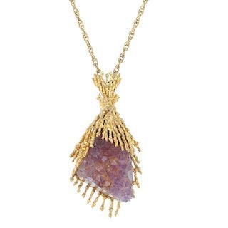 An amethyst geode pendant. The amethyst geode, within an abstract mount, suspended from an integral