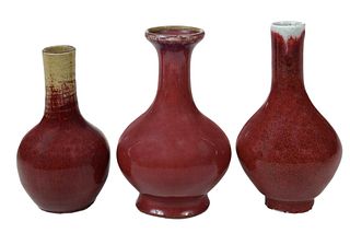 Three Chinese Sang de Boeuf Bottle Form Vases