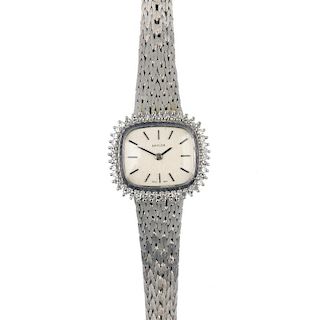 A lady's 9ct gold diamond dress watch. The rectangular-shape dial, with black baton hour markers, to