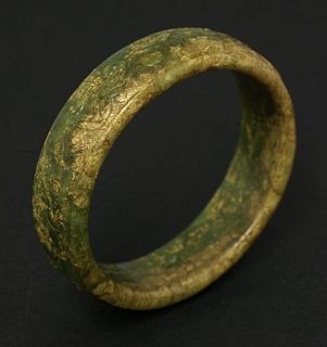 A jade Bangle possibly Ming in green and brown-grey